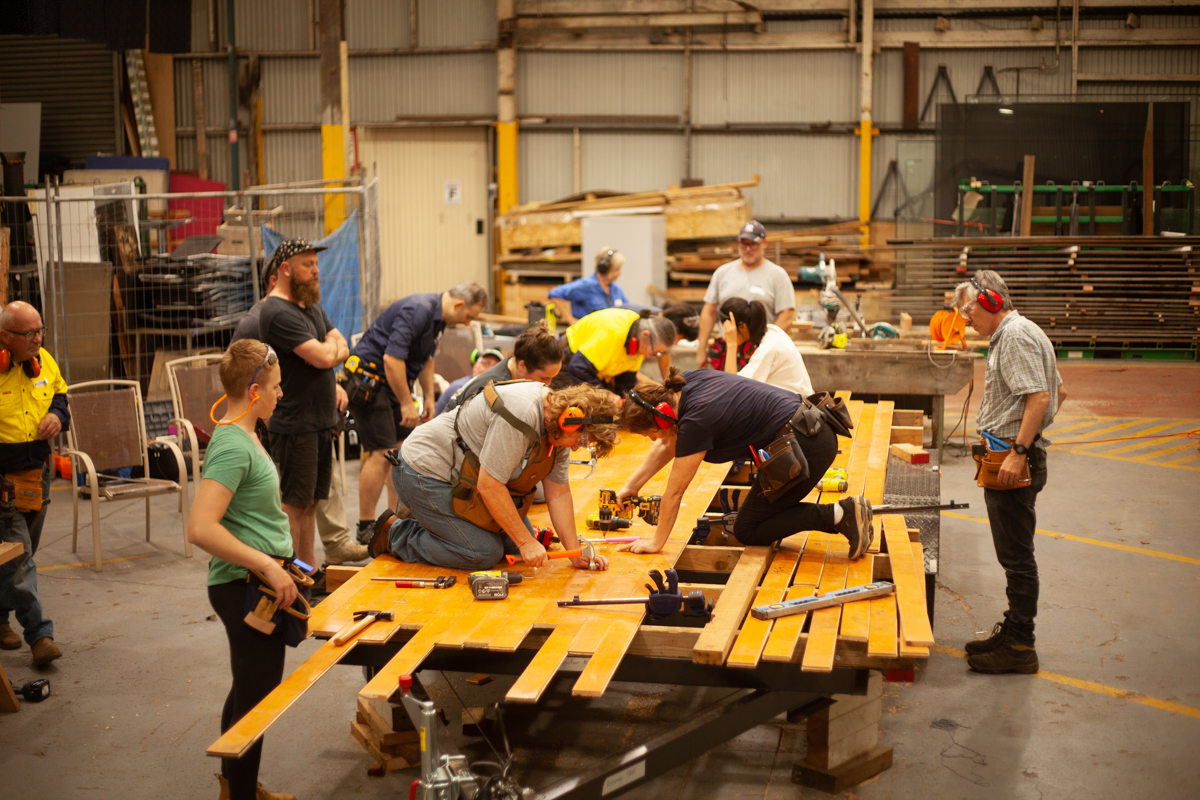 Tiny house building course class working on the floor